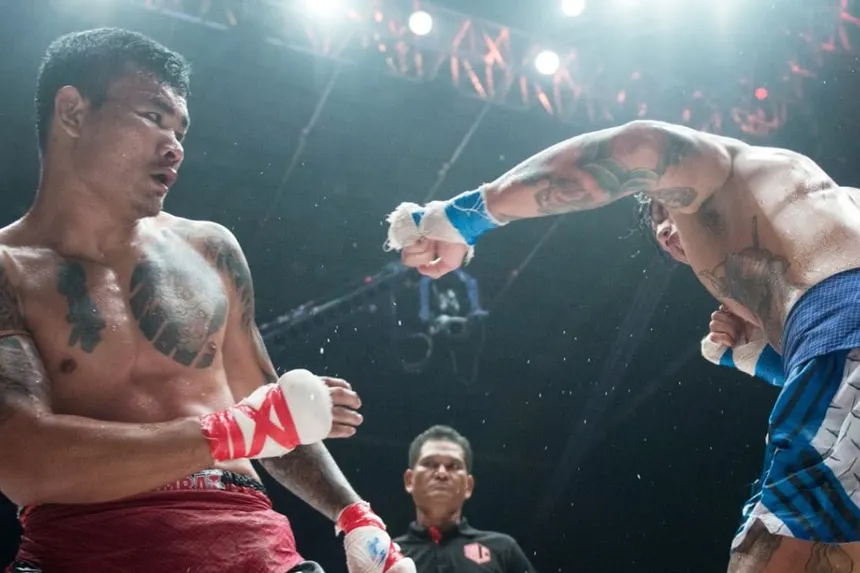 Lethwei fighters exchanging bare-knuckle strikes in the ring